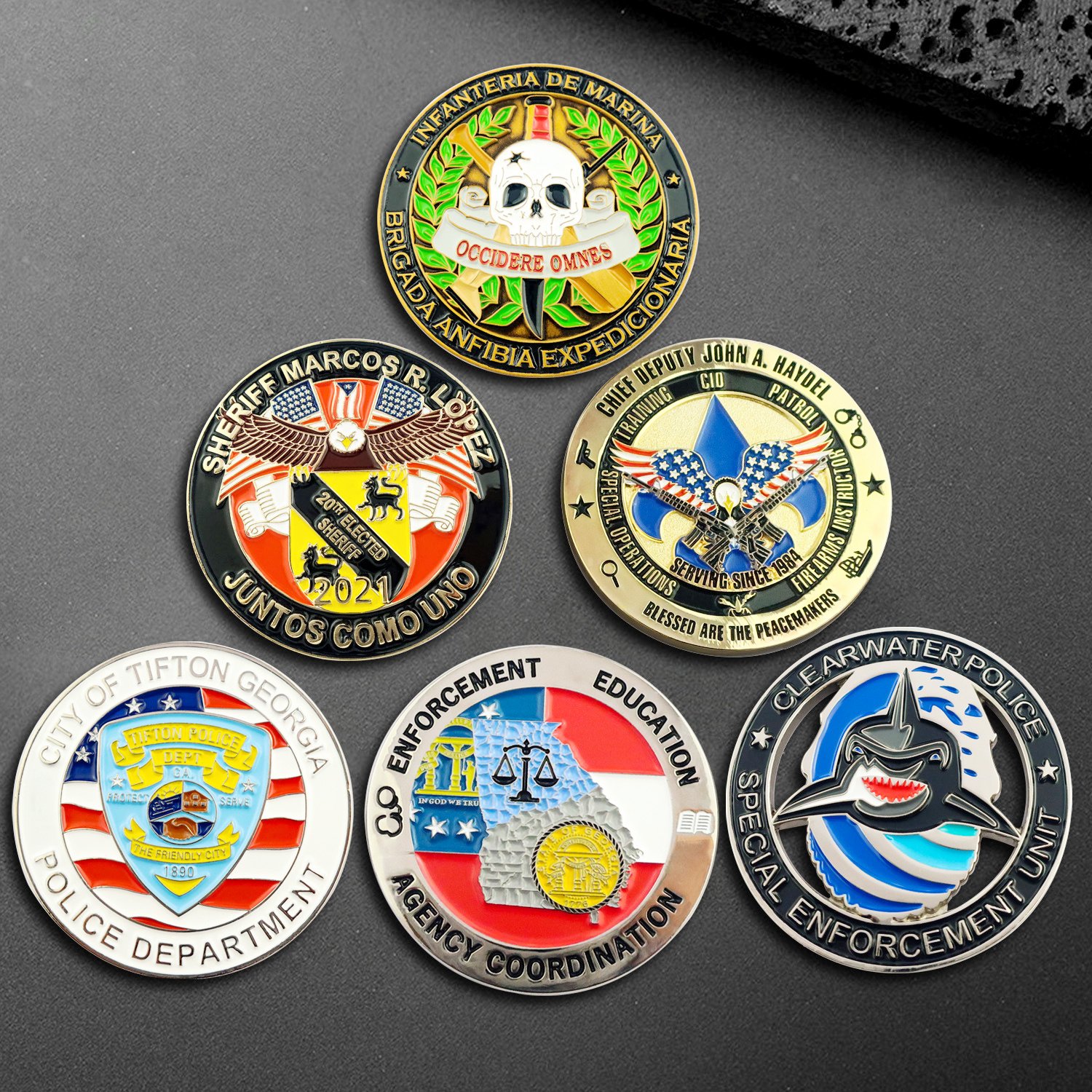 Display showcase of various custom challenge coins with different shapes and platings